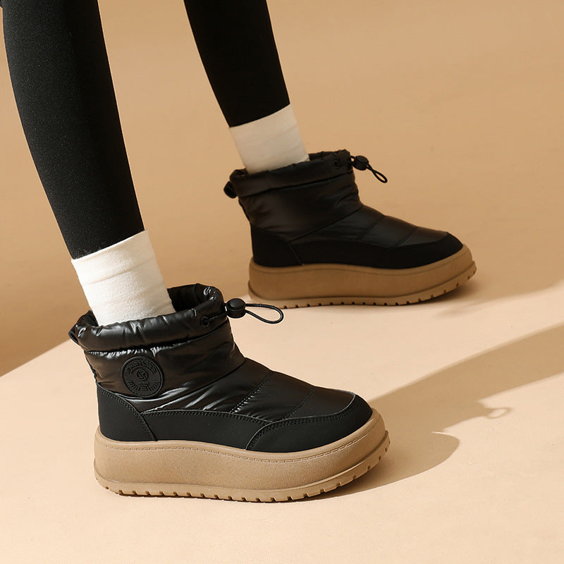Women's black snow boots with padded collar, lace-up front, and textured rubber sole