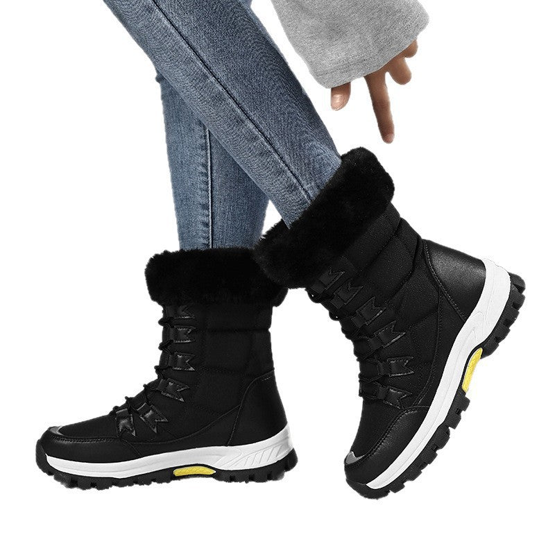 Women’s black mid-calf snow boots with fur cuff and lace-up lugs, cushioned thick sole