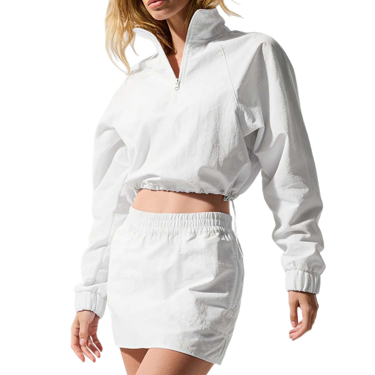 Women’s white quarter-zip jacket and mini skirt set, close-up view