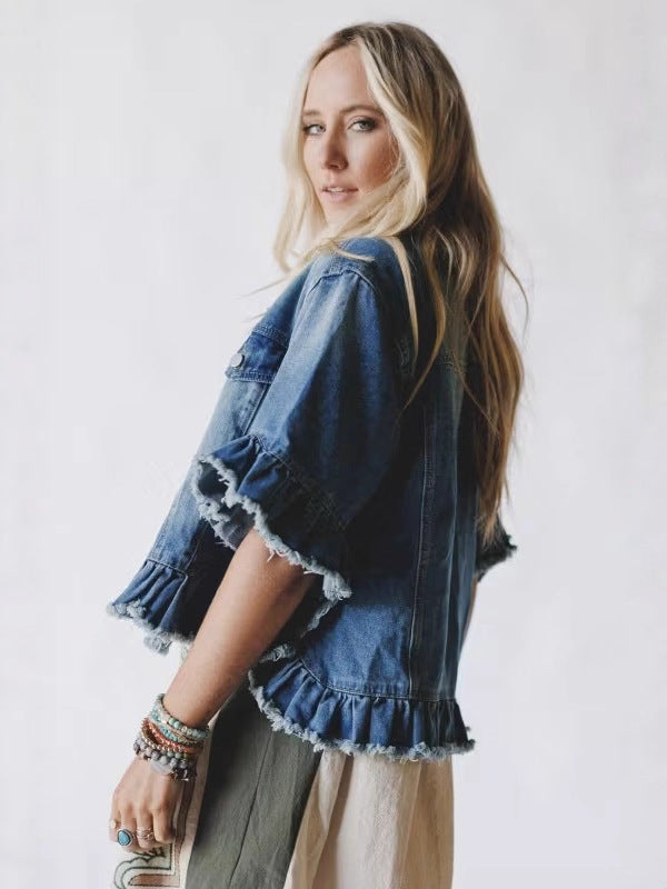 Women's blue denim short-sleeve top with frayed edges, ruffled hem, button front
