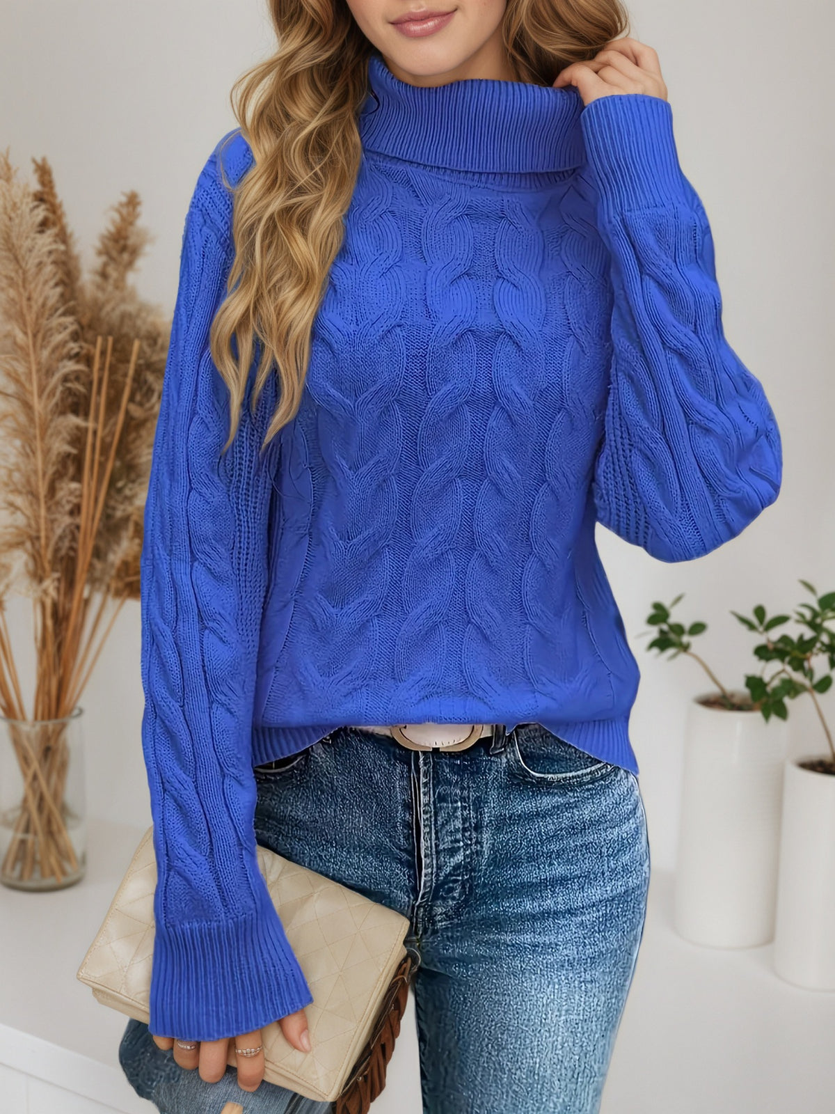 Royal blue knit turtleneck sweater with long sleeves and cable twist texture