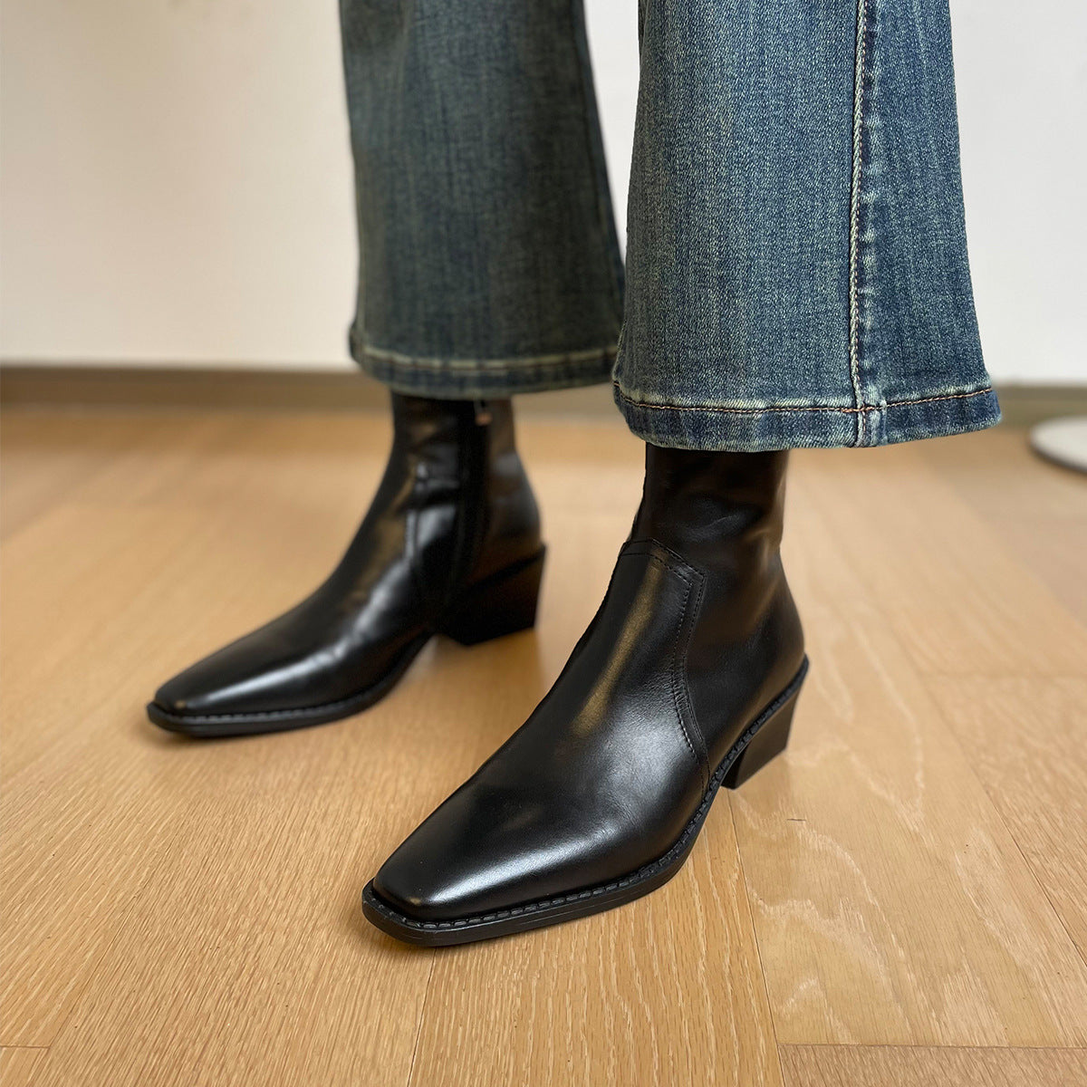 Women's black leather ankle boots with square toe and stacked block heel, back zip