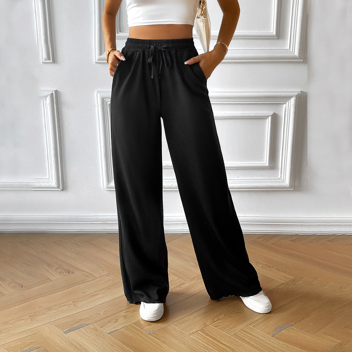 Black wide-leg drawstring pants with elastic waist and relaxed straight silhouette