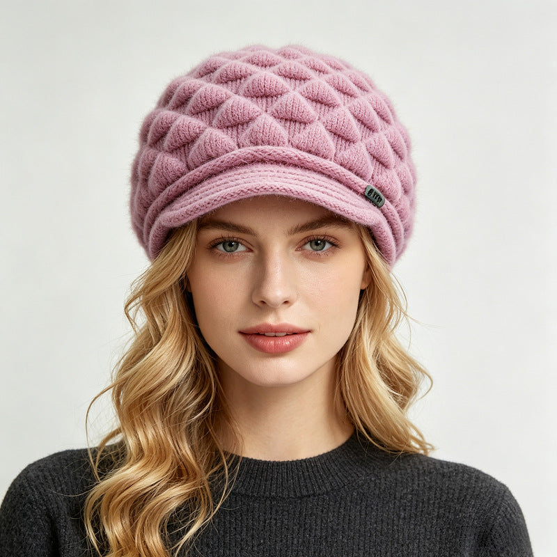 Pink fleece-lined knit beanie with quilted texture and ribbed cuff brim