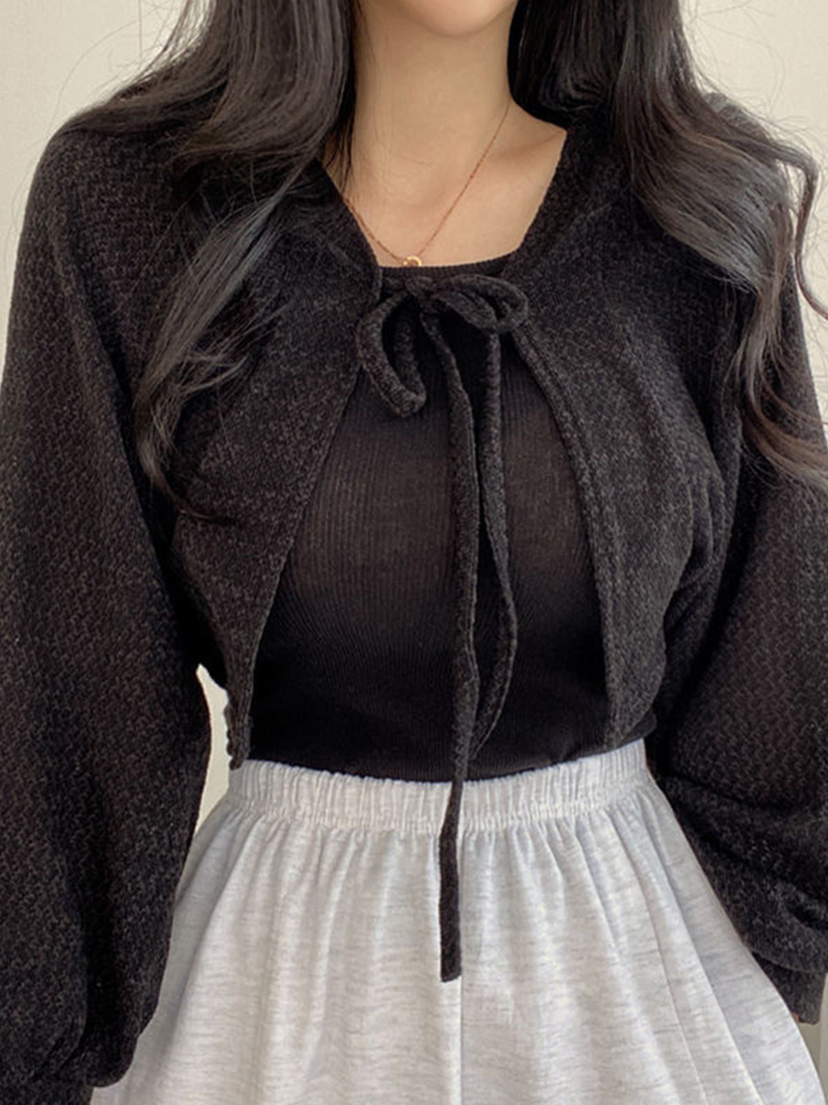 Black cropped tie-front cardigan with long sleeves and bow neckline open knit bolero