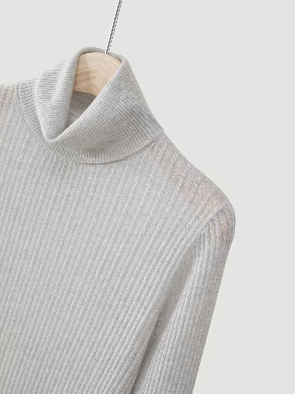 Light gray ribbed high-neck knit sweater collar detail