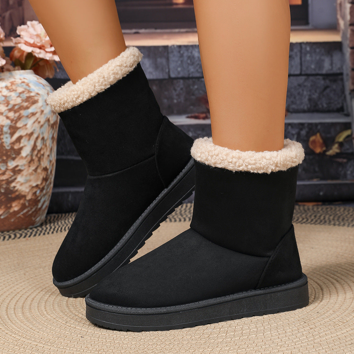 Black suede mid-calf winter boots with plush shearling cuff and rugged rubber sole