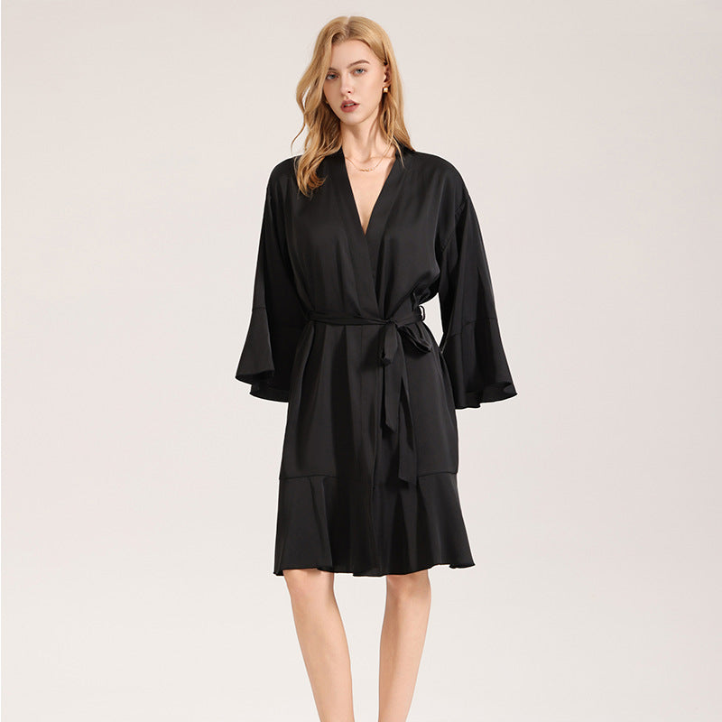 Black satin robe with V-neckline, waist tie, and mid-length layered skirt hem