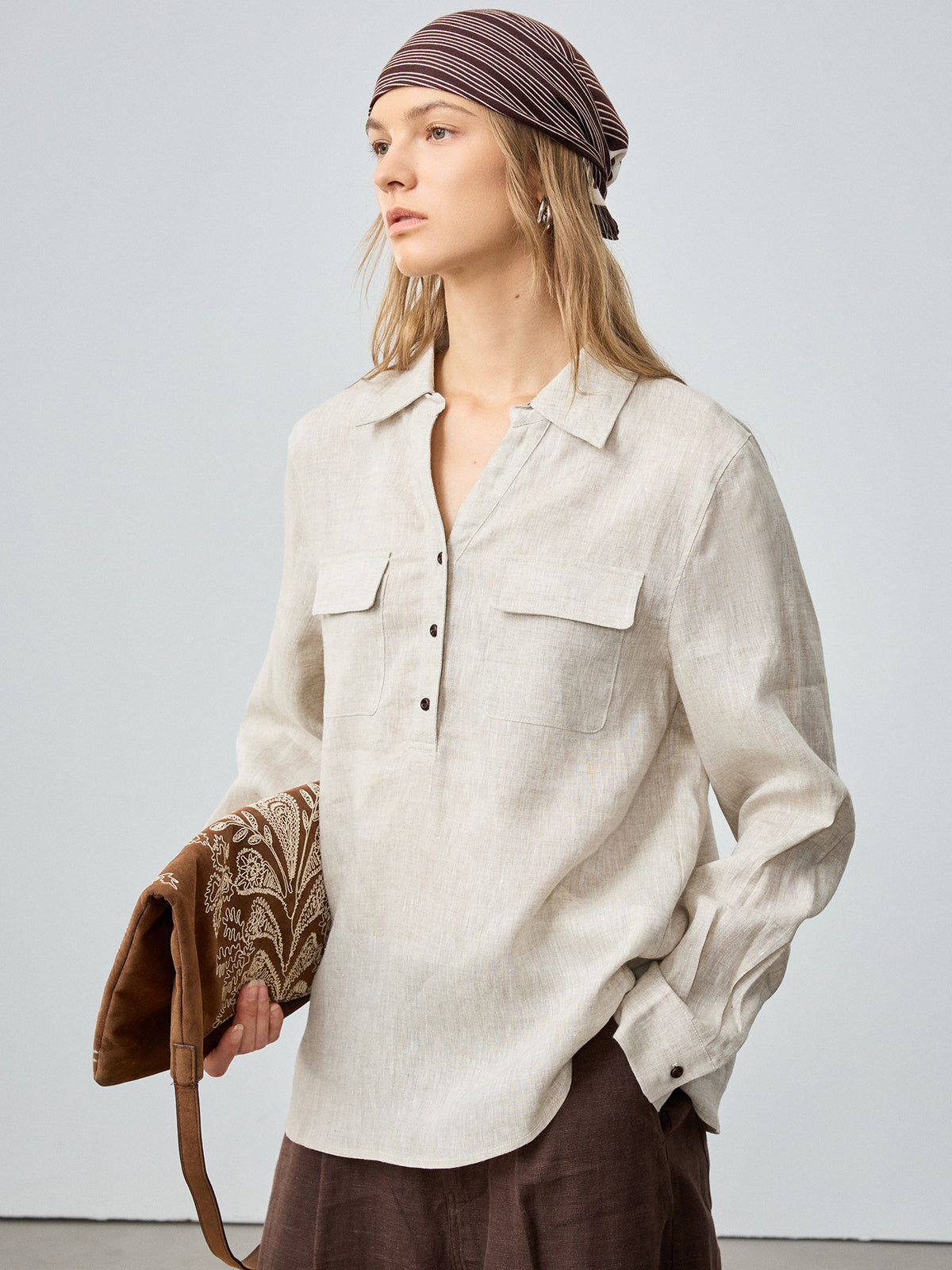 Women’s off-white linen button-up shirt with pointed collar and two chest flap pockets