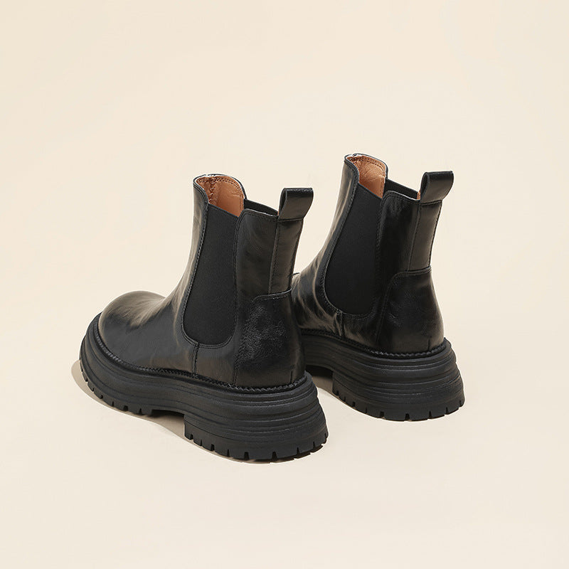 Black leather Chelsea boots with elastic gores and chunky platform lug sole