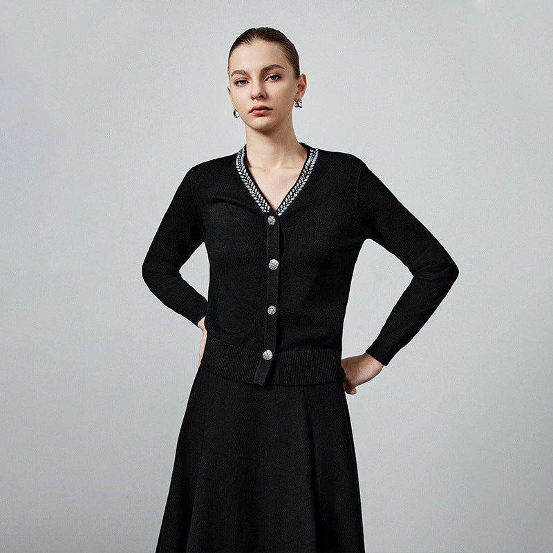 Black knit cardigan with V-neck and beaded neckline trim, long sleeves, button front