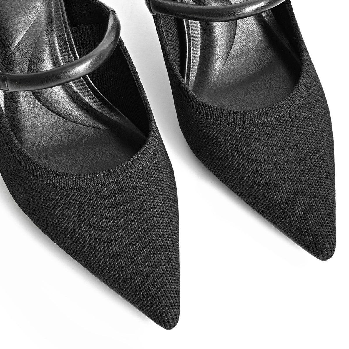 Black pointed-toe mule heels close-up with single strap and square buckle