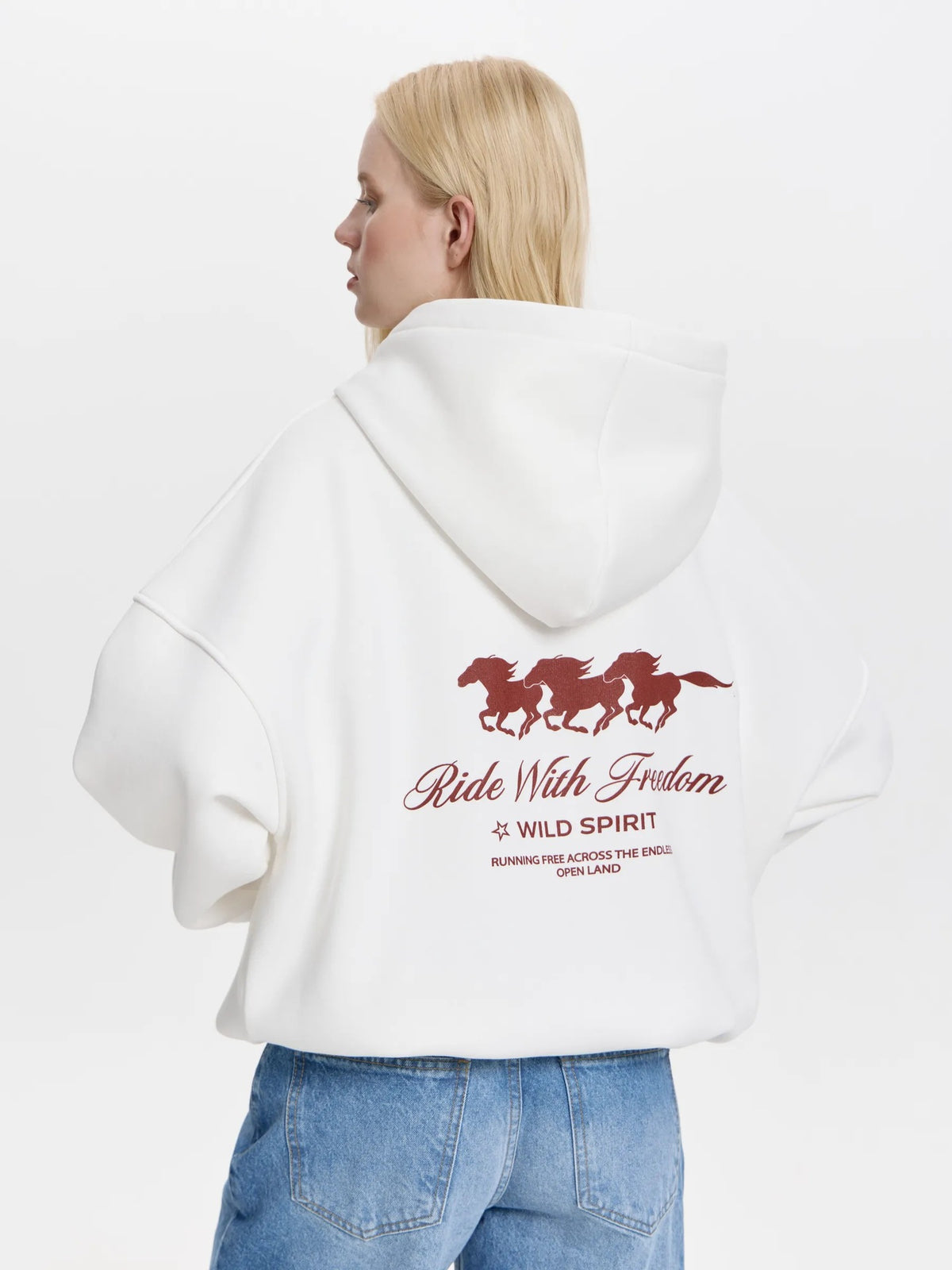 White oversized hoodie, back horse graphic and 'Ride With Freedom' lettering