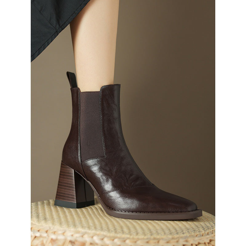 Dark brown leather ankle boot in side view, showing its square toe and striped block heel