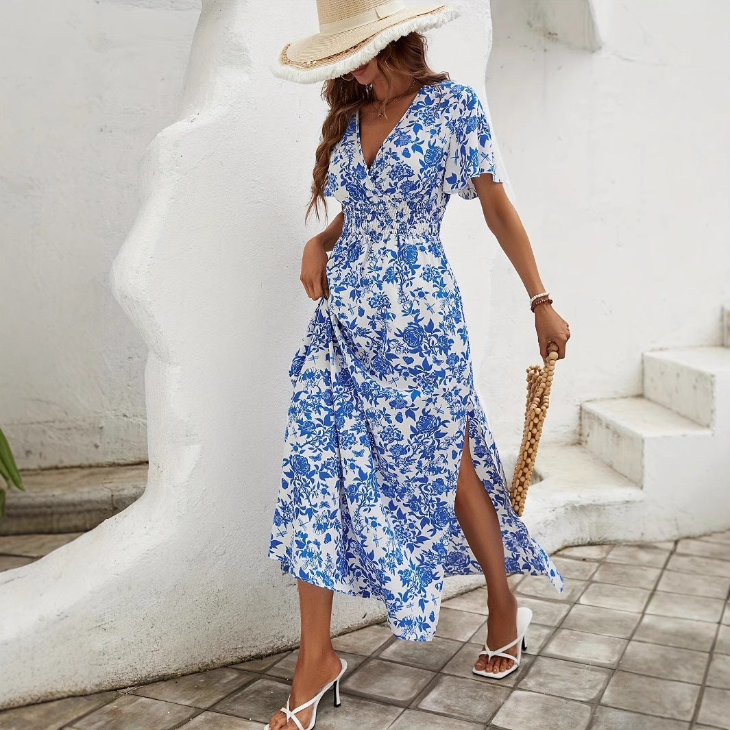 Blue floral maxi dress with flutter sleeves, smocked waist, and front slit