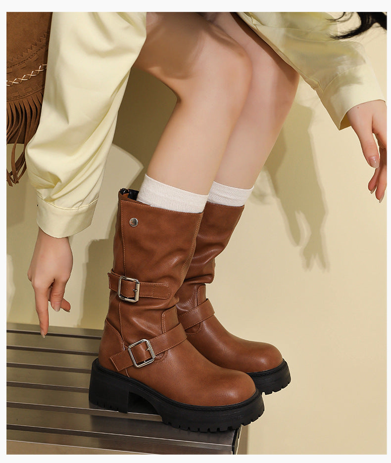Brown mid-calf buckle boots with two strap buckles and rugged thick sole.