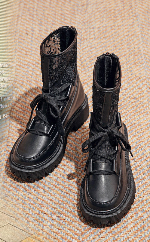 Black lace-up ankle boots with chunky tread sole and mesh-look side panels