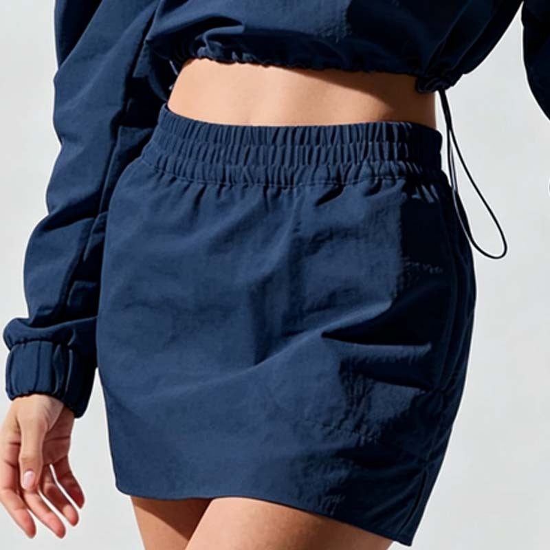 Navy pull-on mini skirt with elastic waistband, back seam, and side pockets