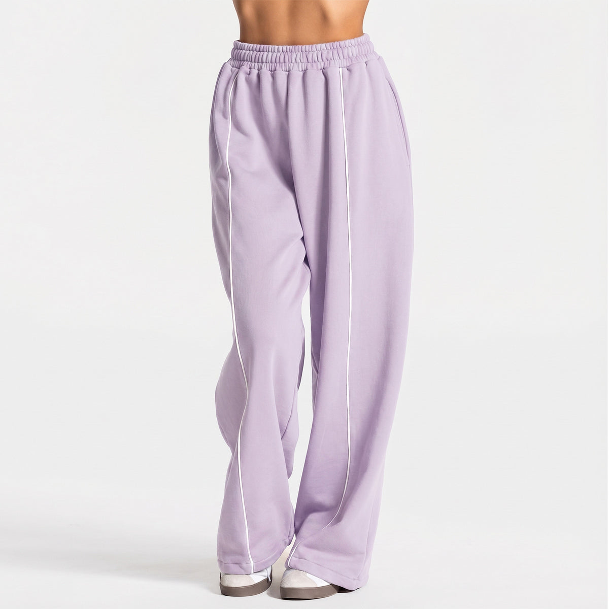 Loose yoga pants in light purple with elastic waistband and vertical side stripe.