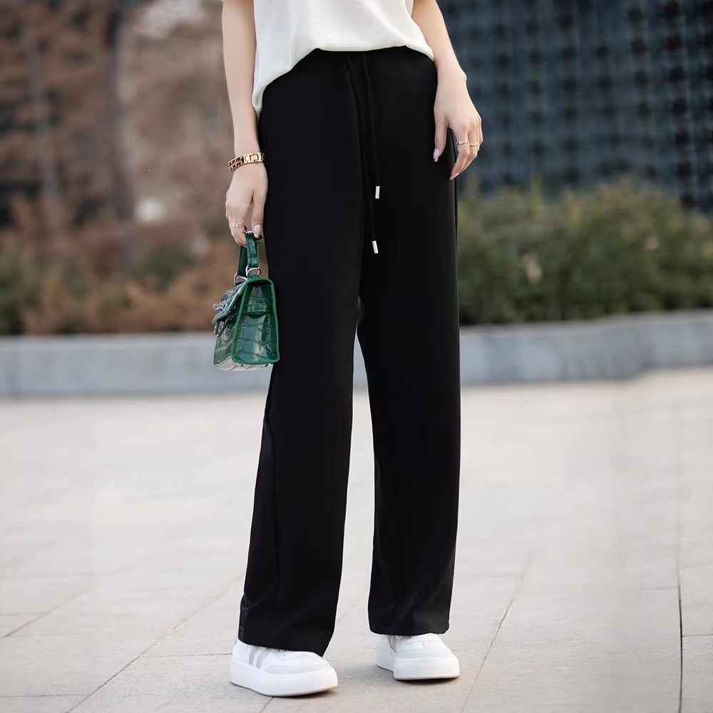 Women’s black wide-leg pants with elastic waistband, drawstring, and relaxed straight legs