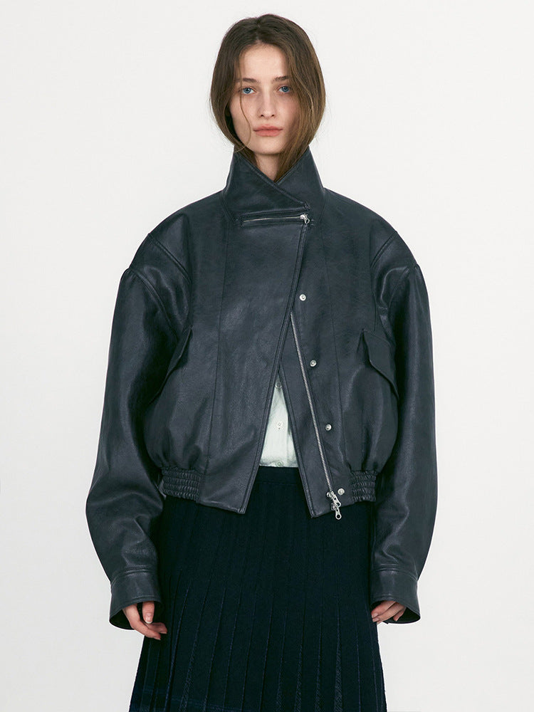 Women's dark green leather cropped jacket with zip front, snap details, ribbed cuffs