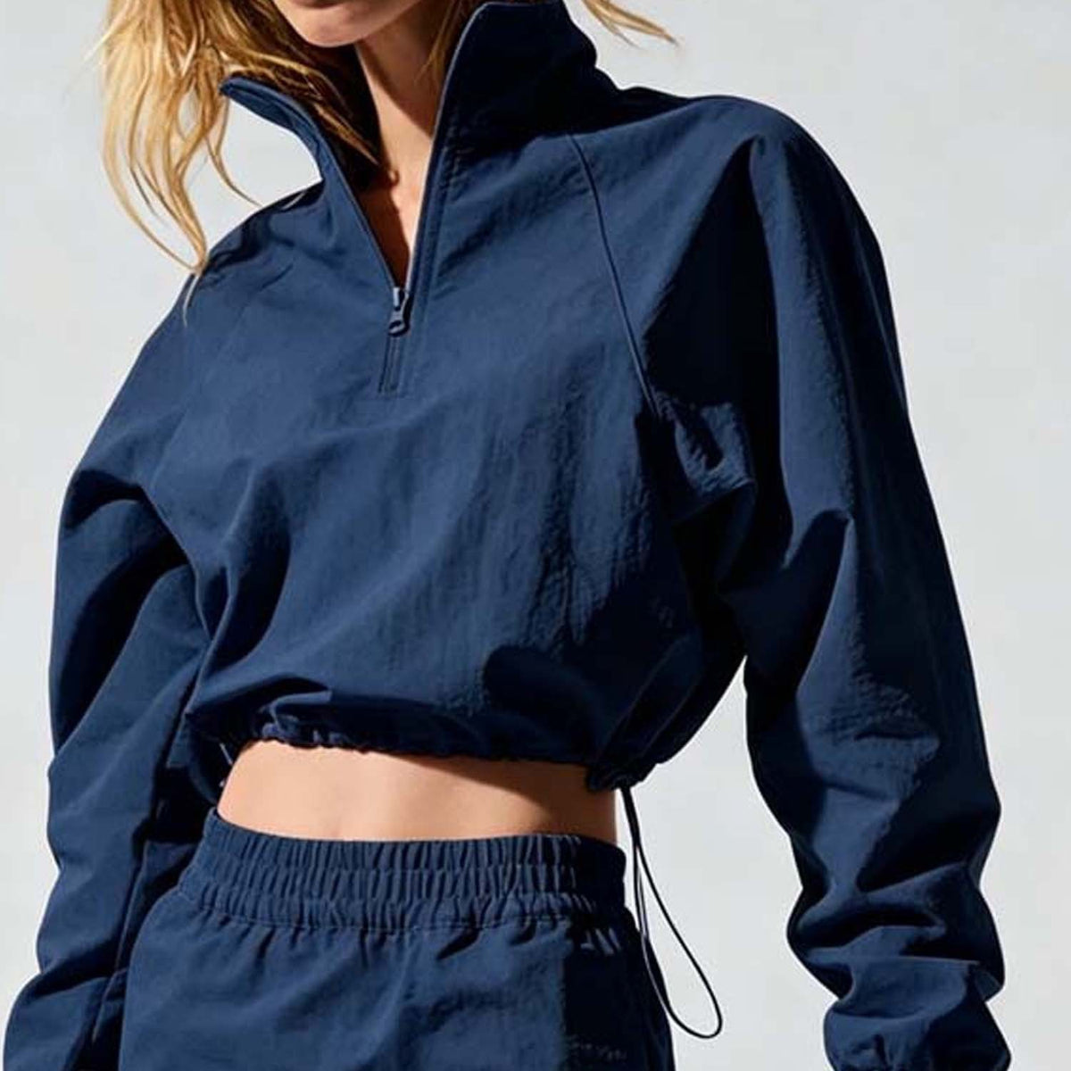 Navy cropped quarter-zip wind jacket with elastic mini skirt