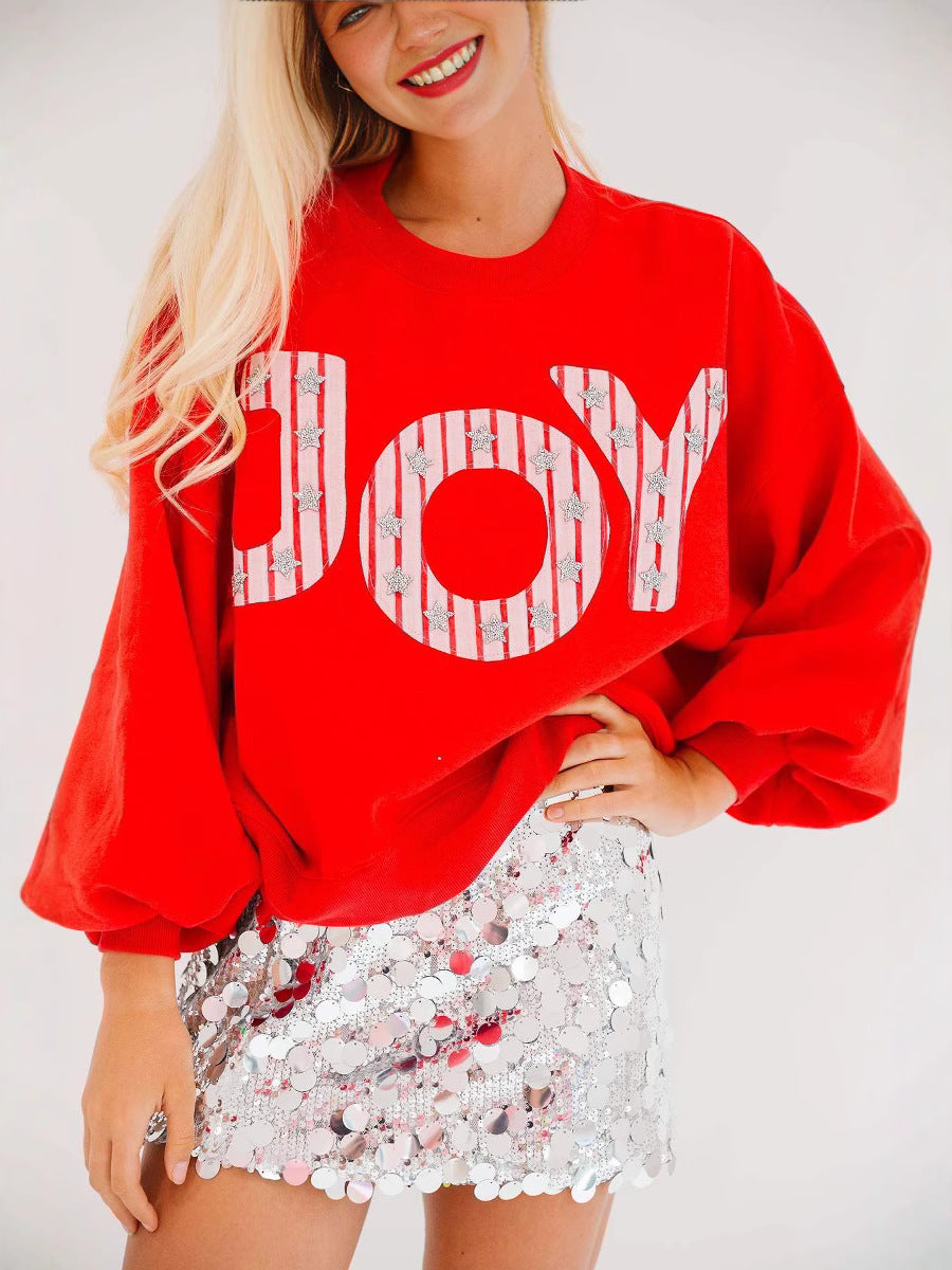 Red women's knitted pullover with large white letter graphic and long sleeves