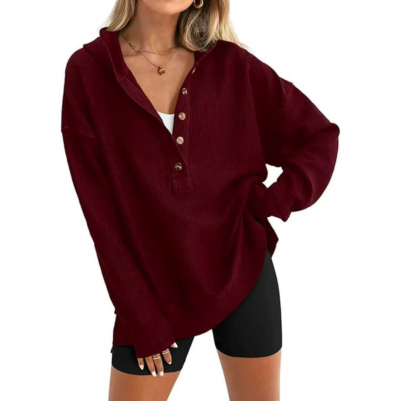 Dark red hooded henley sweatshirt detail: button placket and ribbed cuffs