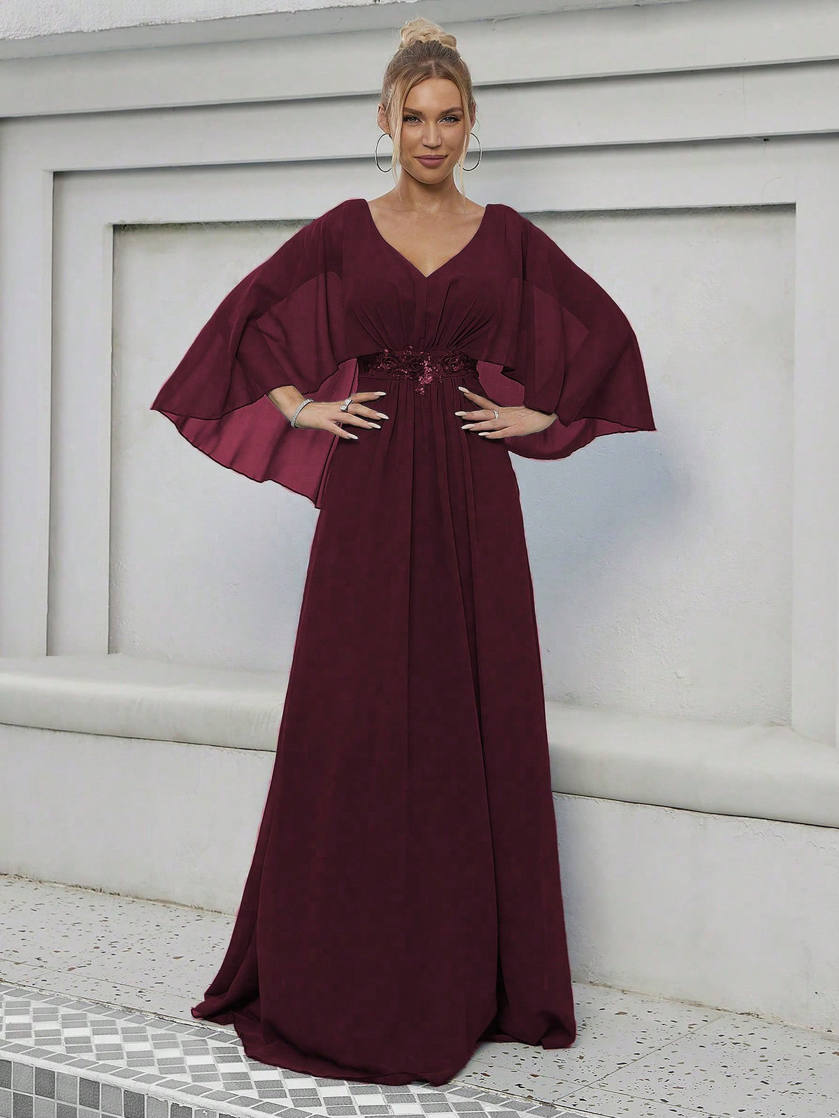 Burgundy V-neck evening dress with cape sleeves and gathered waist applique