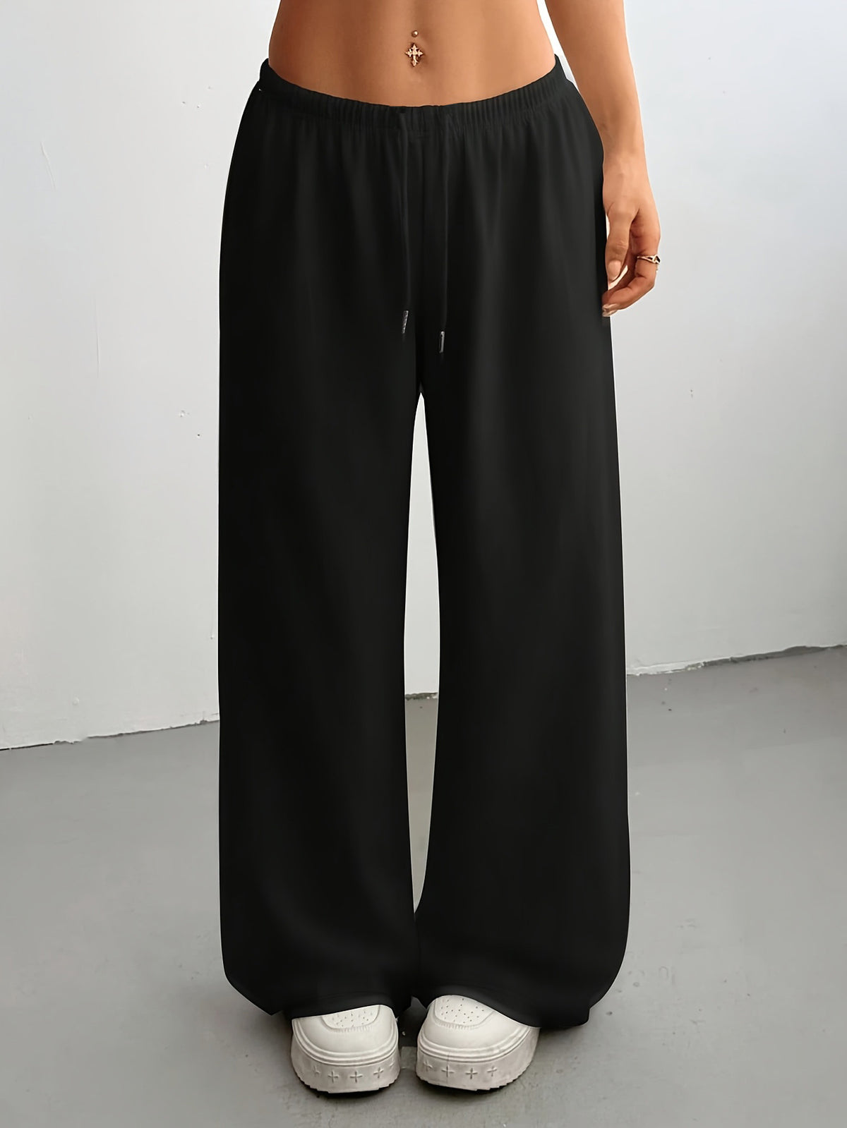 Women's high-waisted wide-leg sweatpants in black, loose fit with drawstring.