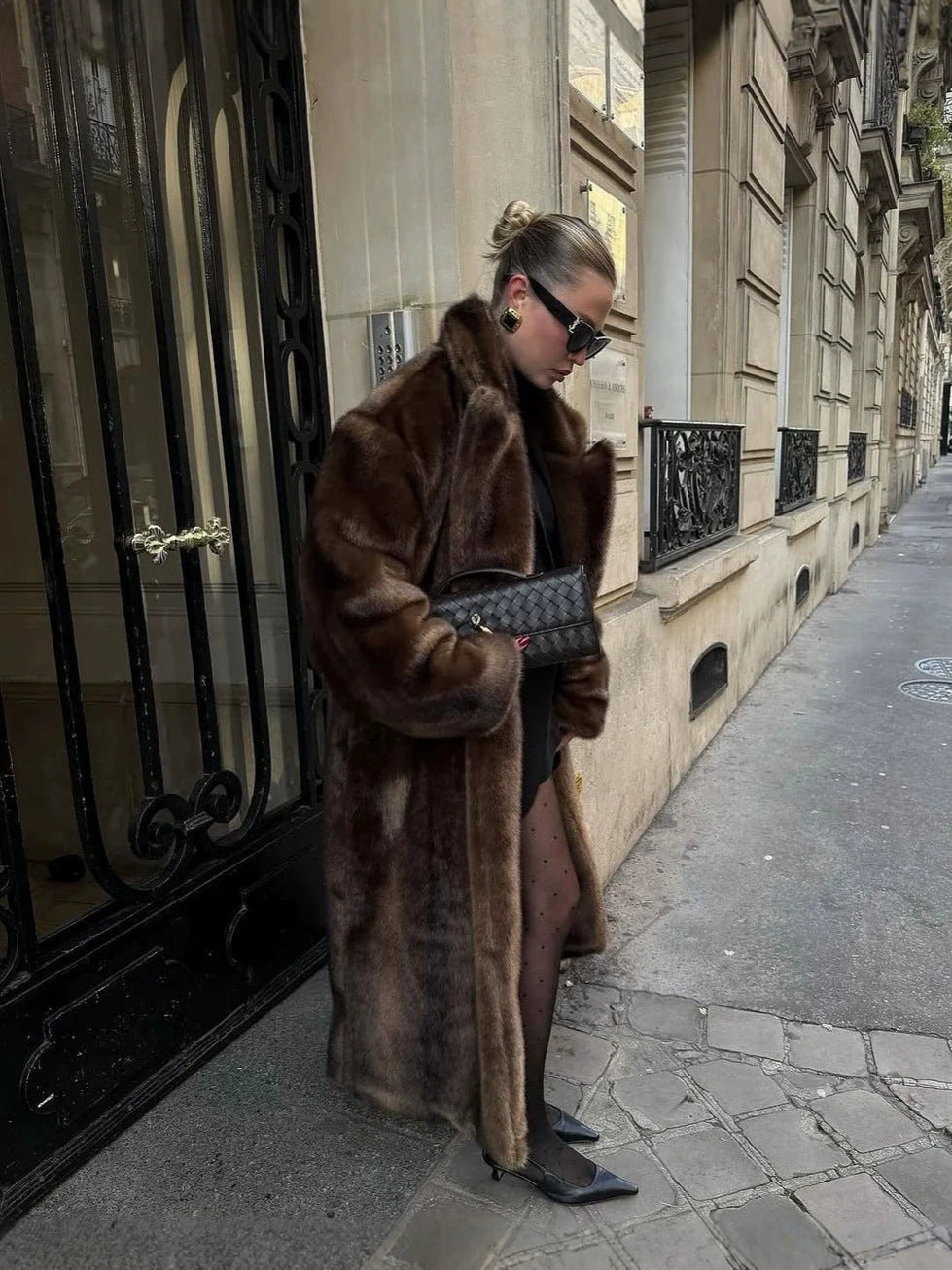 Long dark brown faux fur coat with wide lapels and loose fit, plush texture