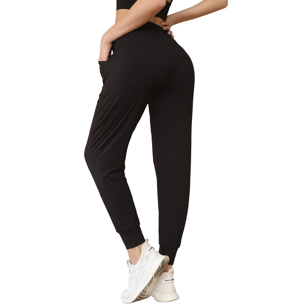 Black tapered jogger pants with elastic waist and drawstring, side pockets