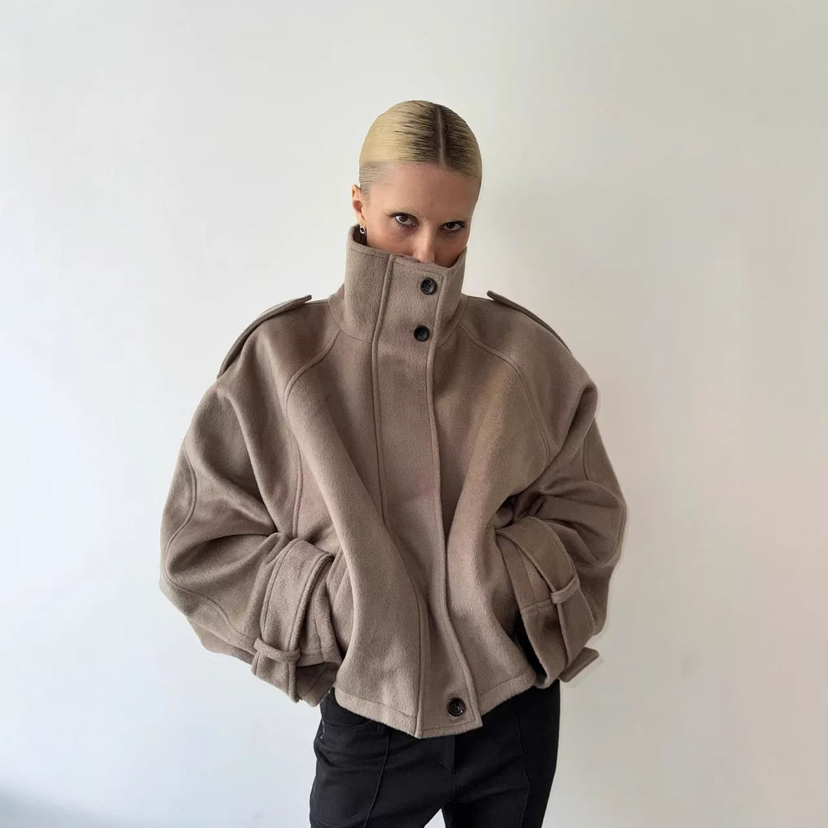 Khaki wool jacket with stand-up collar and snap buttons, loose casual fit.