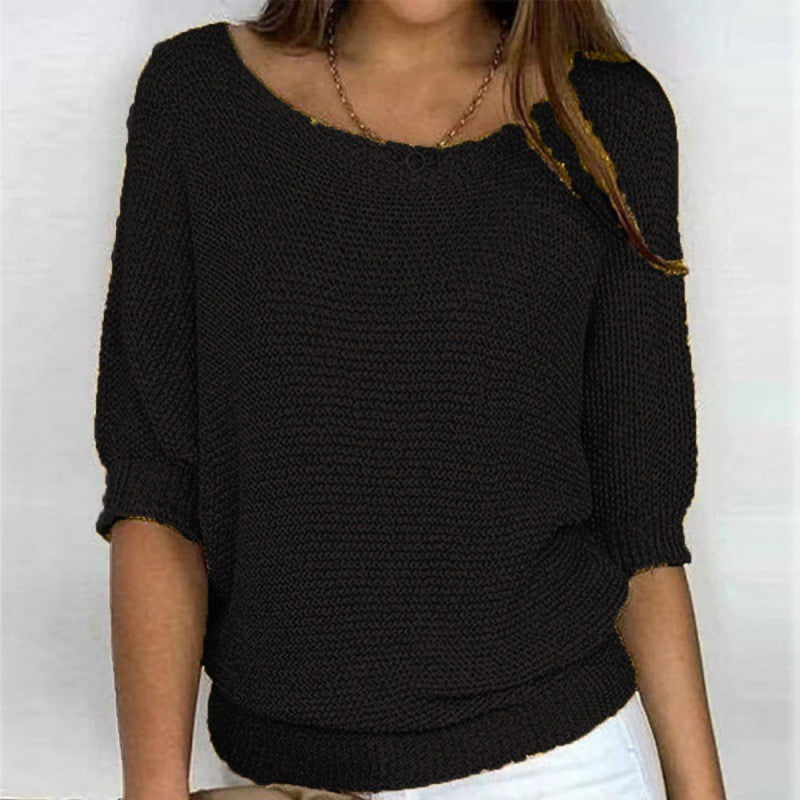 Black textured knit top with round neck and three-quarter sleeves, ribbed cuffs