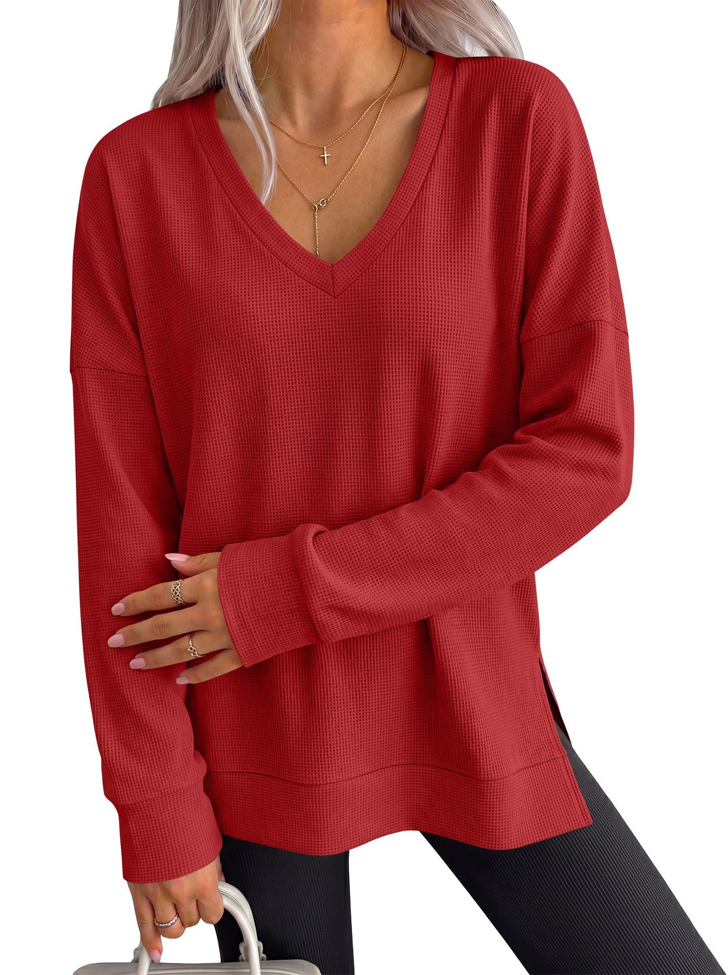 Women’s red V-neck long-sleeve waffle knit loose T-shirt top with wide neckline.