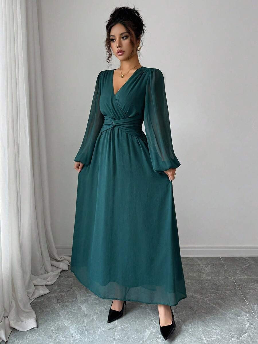 Teal green chiffon maxi dress with long sleeves, wrap front, cinched waist.