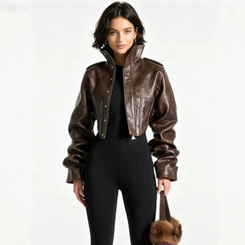 Women's brown leather jacket with stand collar, front zipper, and flap pockets