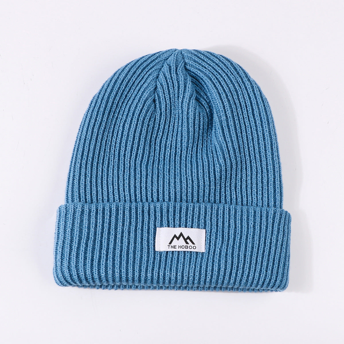 Blue ribbed knit beanie with fold-up cuff and THE HOBOO logo patch