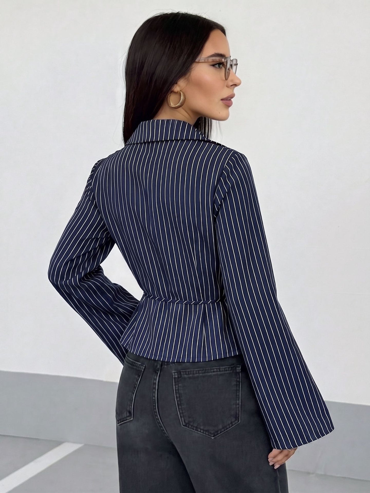 Navy pinstripe long-sleeve blouse with collared V-neck and tied waist detail
