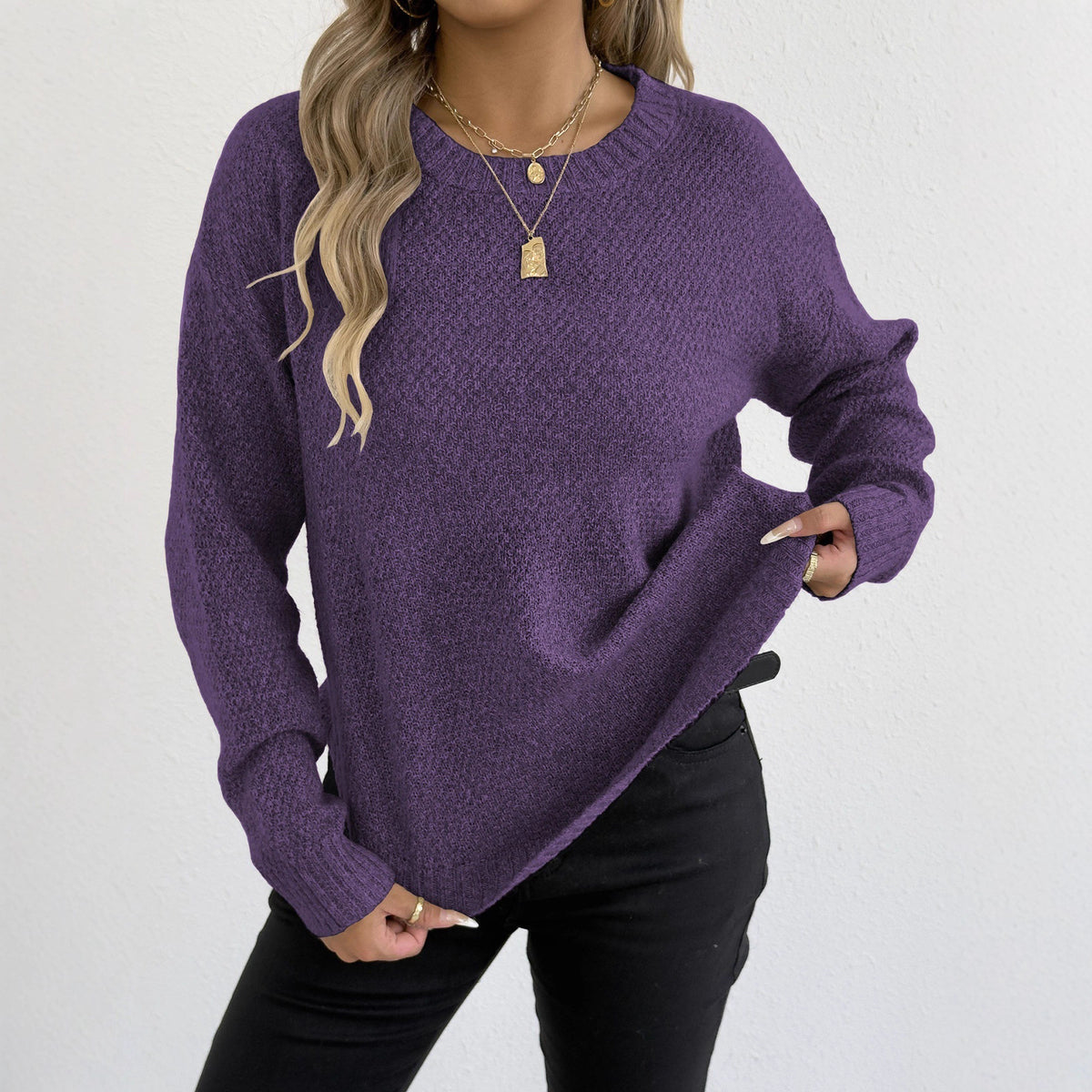 Purple knit pullover sweater with round neckline and long sleeves
