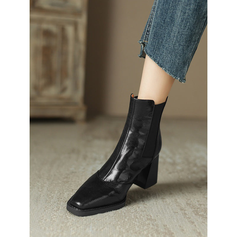 Black leather ankle boot shown from the front with square toe, elastic gusset and block heel