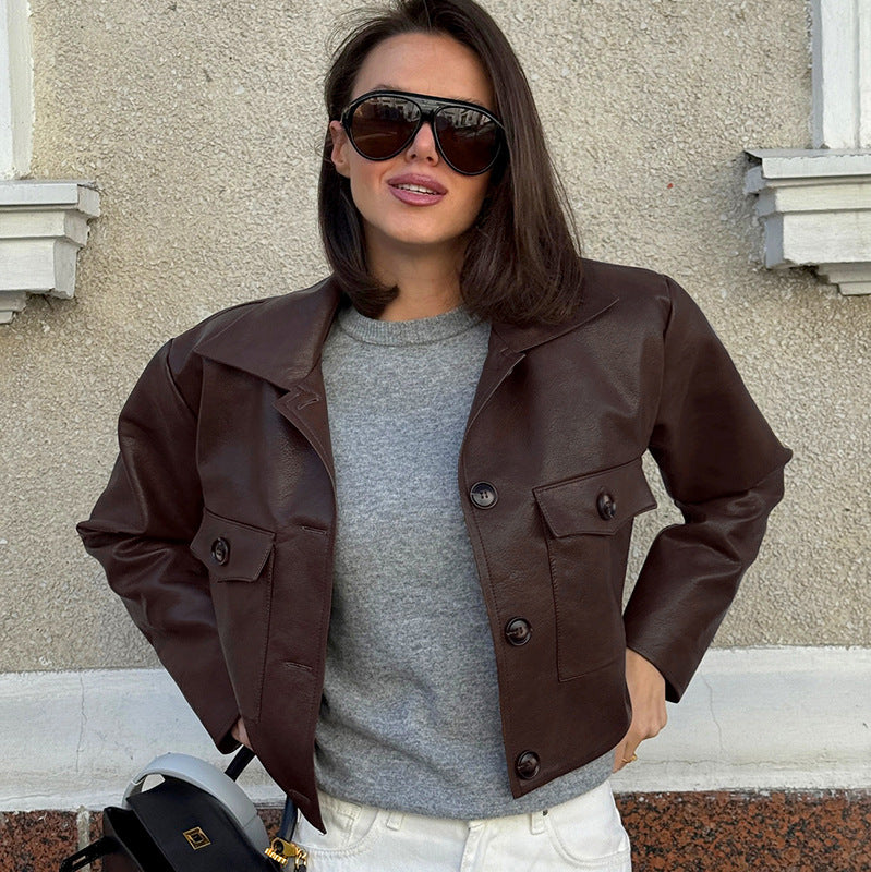 Brown women’s leather biker jacket with snap buttons and side pocket details