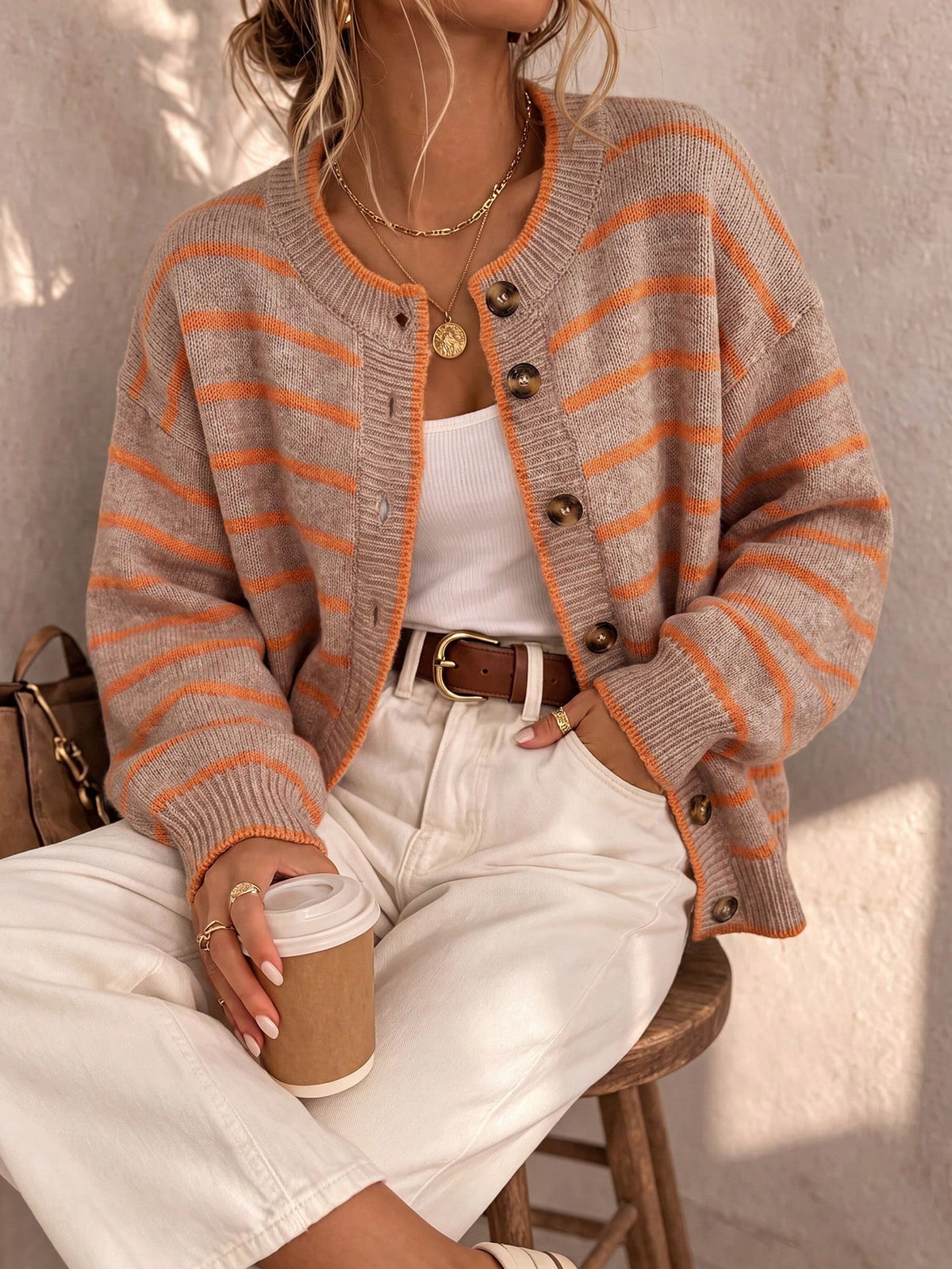Light blue striped knit cardigan with orange stripes and large dark button front