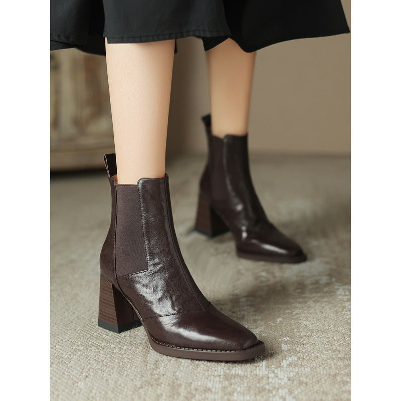 Pair of dark brown square-toe Chelsea boots with elastic gussets and block heels