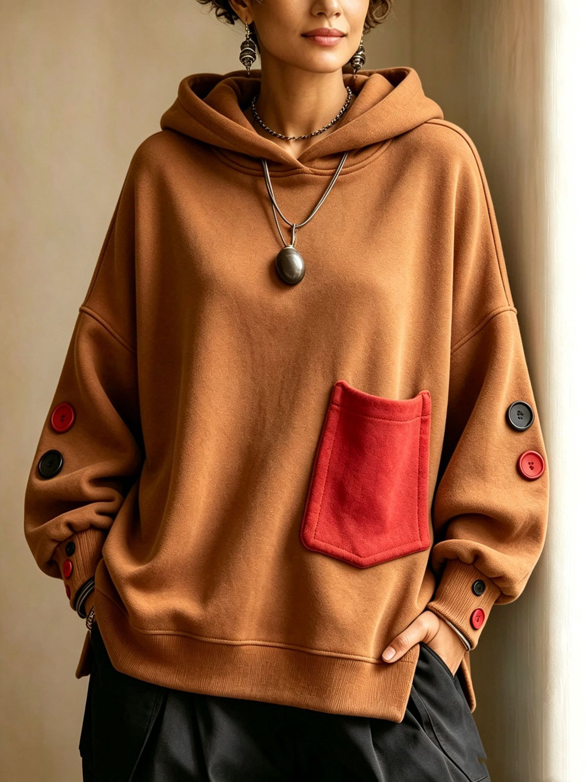 Brown pullover hoodie with front kangaroo pocket, hood drawstrings, buttoned sleeve cuffs