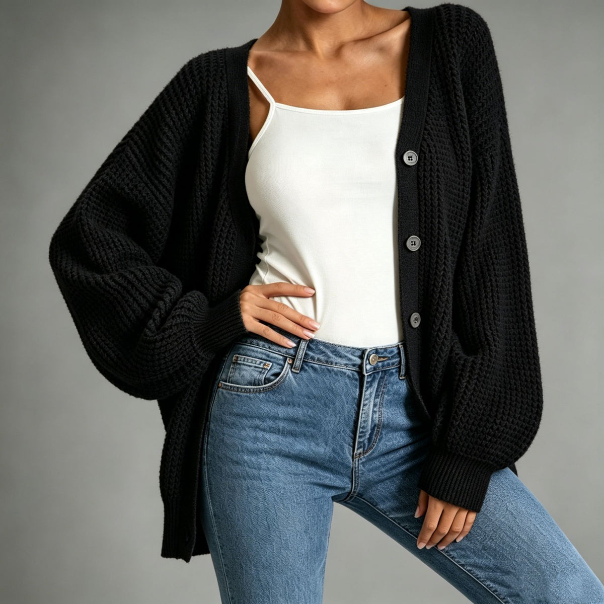 Black chunky knit cardigan with button front, shawl collar, ribbed cuffs