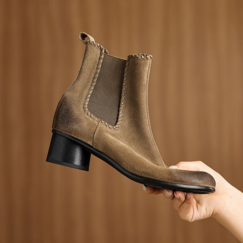 Apricot suede Chelsea ankle boot held in hand, round toe, chunky low block heel