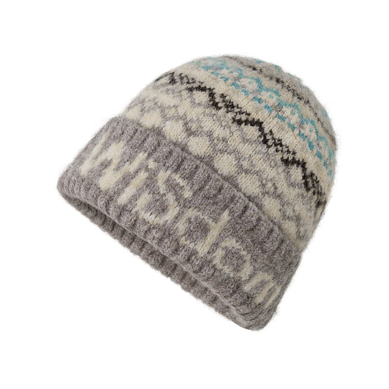 Gray knit beanie with cream and turquoise Fair Isle design and ribbed texture