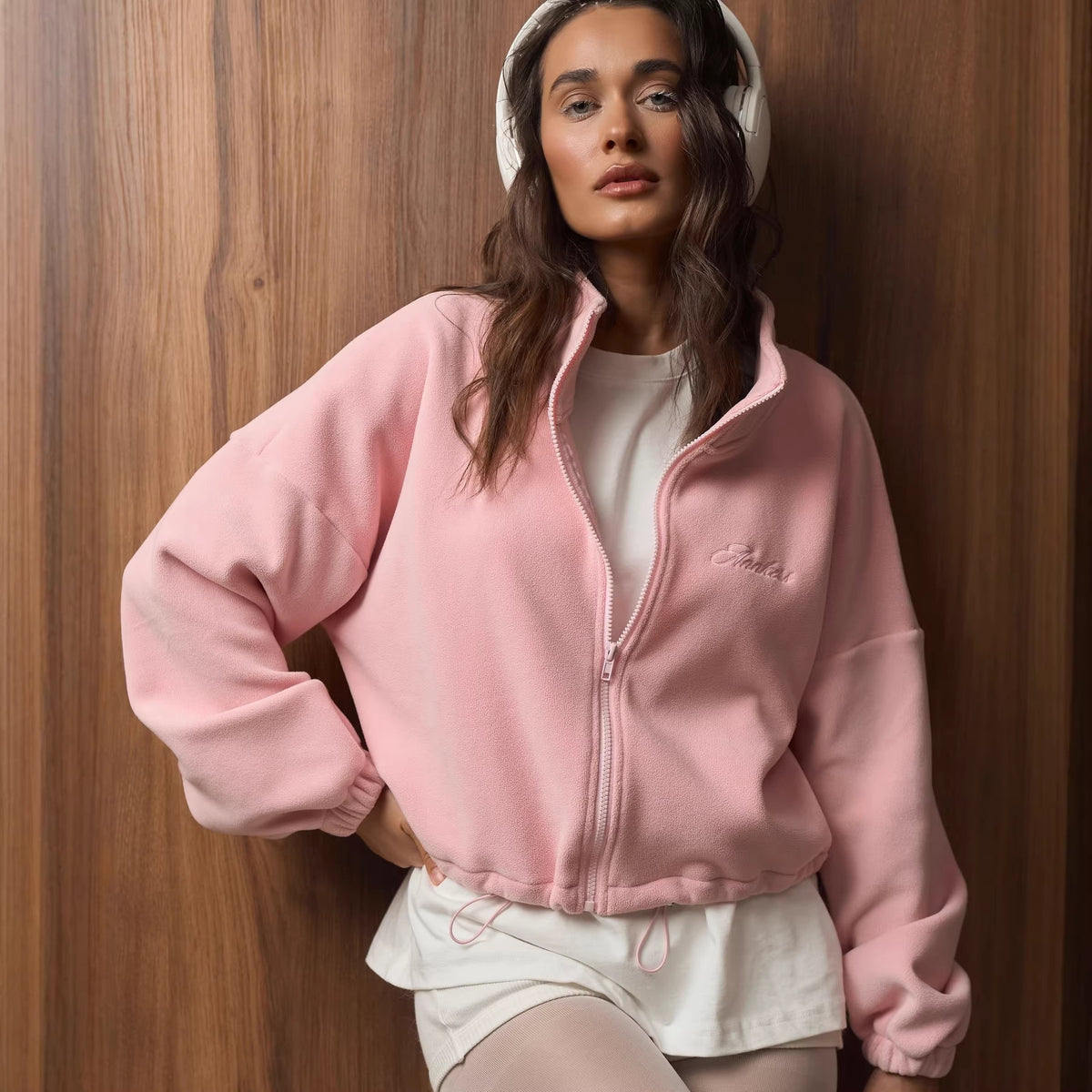 Women's light pink fleece zip jacket with embroidered logo, front zipper and cuffs