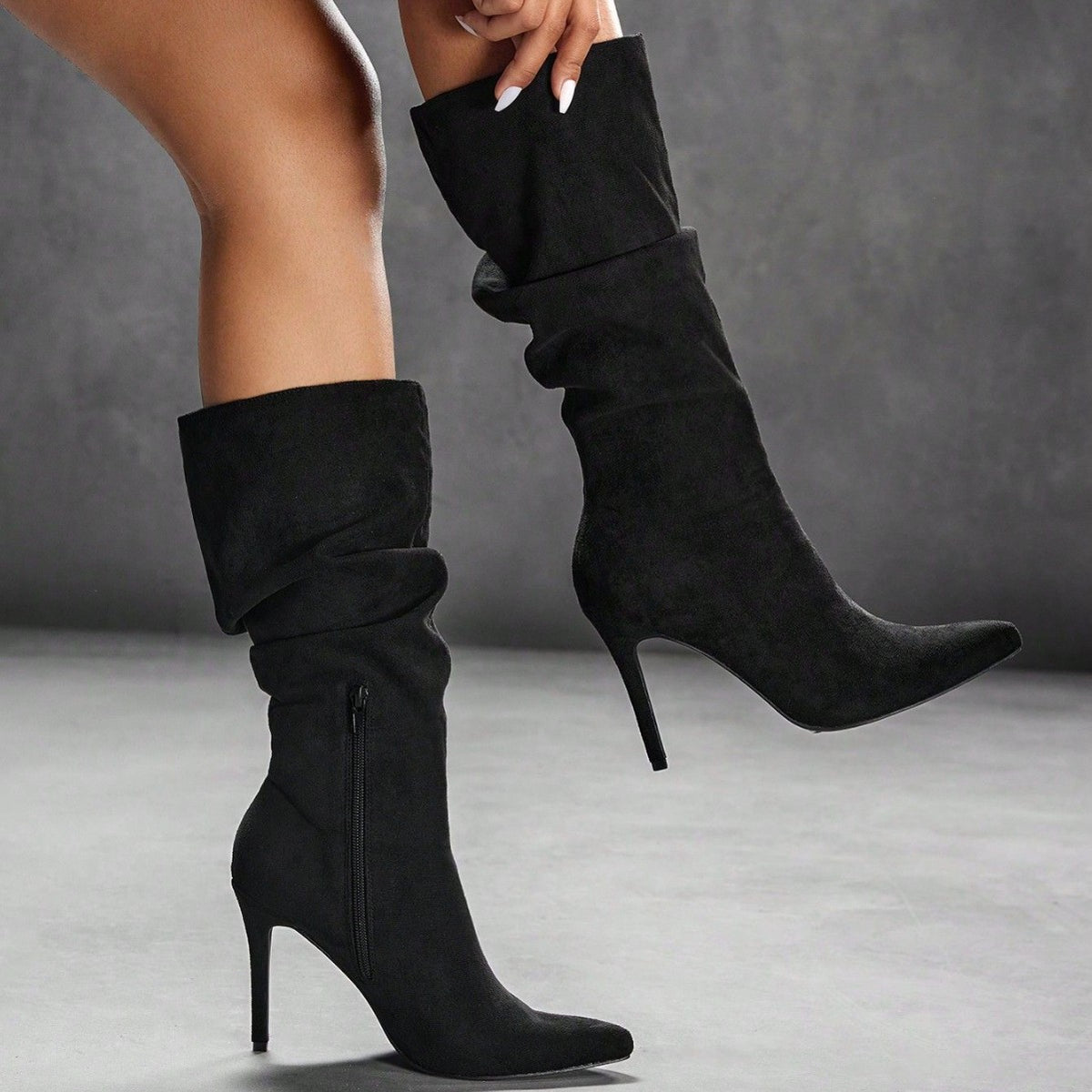 Black suede over-the-knee boots with ruched cuff, pointed toe, stiletto heel, side zip